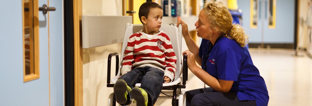 Young boy in wheelchar with nurse